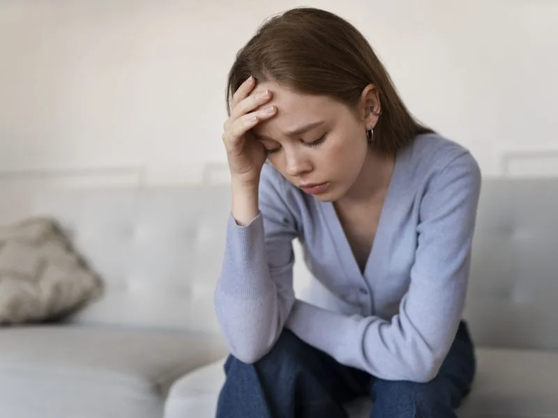 anxious-woman-sitting-home-front-view